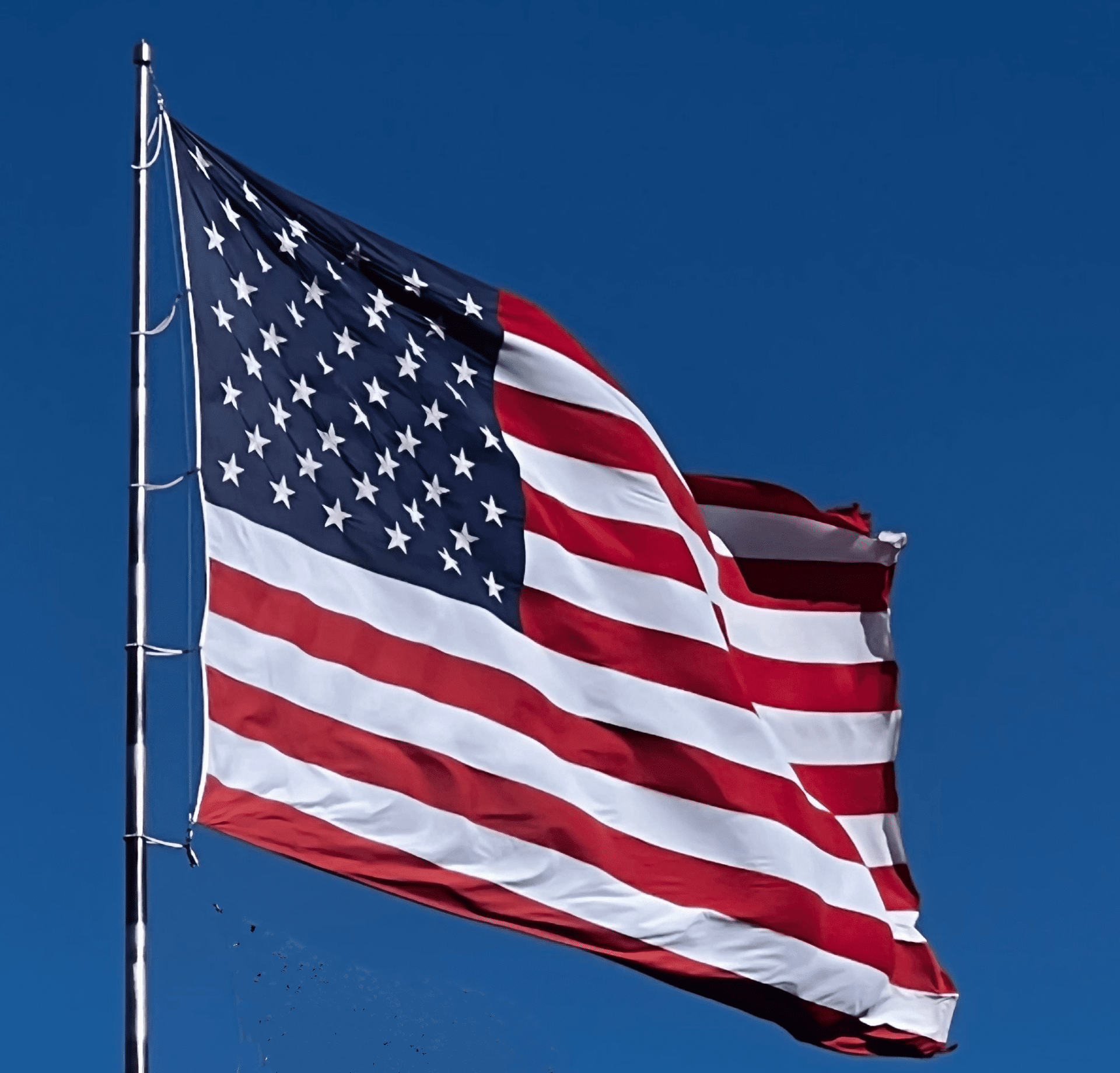 American Flag And Bright Blue Sky